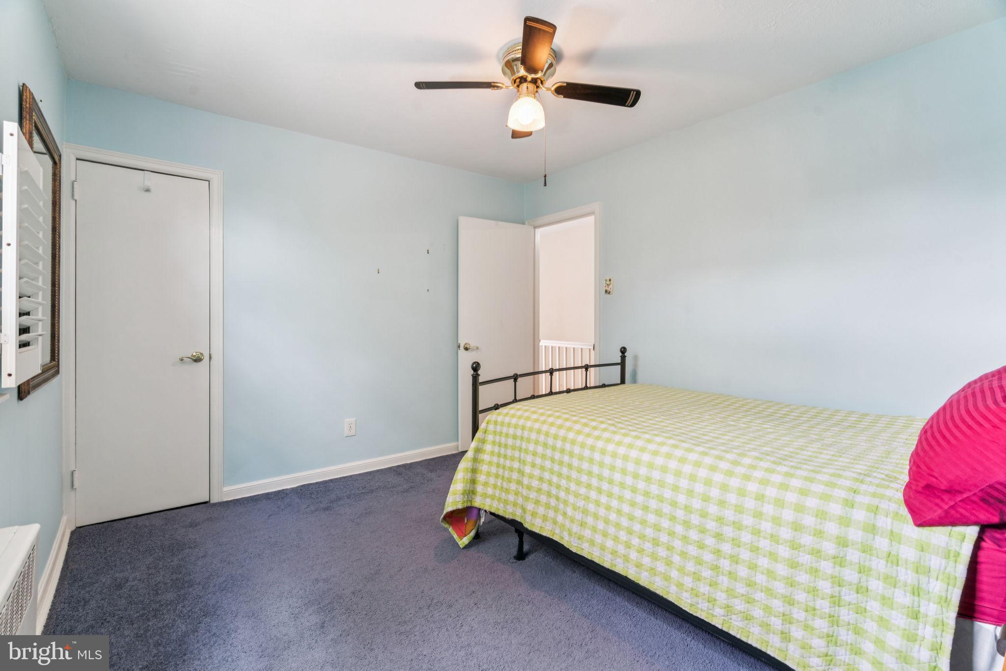 6768 Stenton Avenue Philadelphia, PA 19119 - Photo 53 of 76 a bedroom with a bed and a chandelier