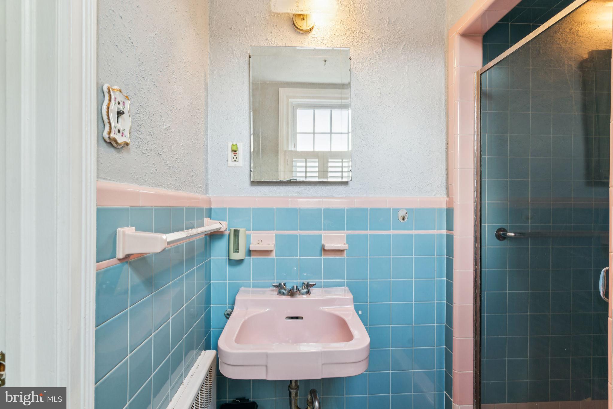 6768 Stenton Avenue Philadelphia, PA 19119 - Photo 64 of 76 a bathroom with a sink a mirror and a bathtub
