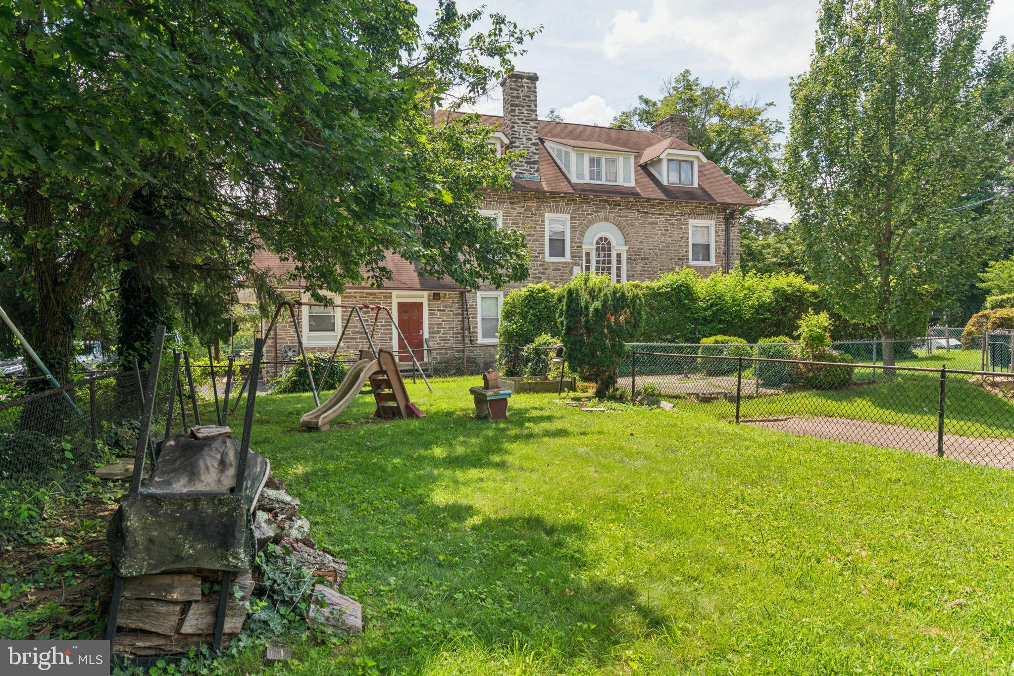 6768 Stenton Avenue Philadelphia, PA 19119 - Photo 70 of 76 a front view of a house with swimming pool and garden