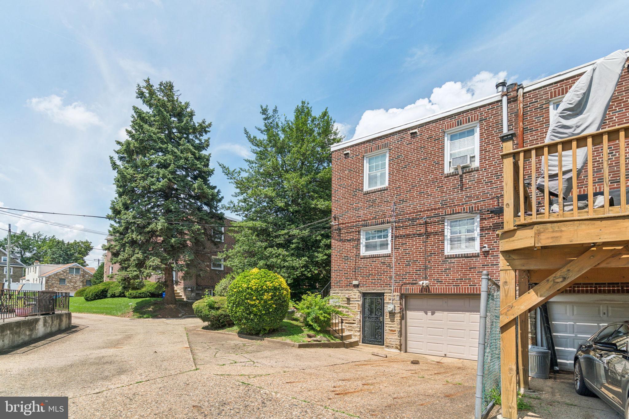 6768 Stenton Avenue Philadelphia, PA 19119 - Photo 71 of 76 a front view of a building with garden and trees