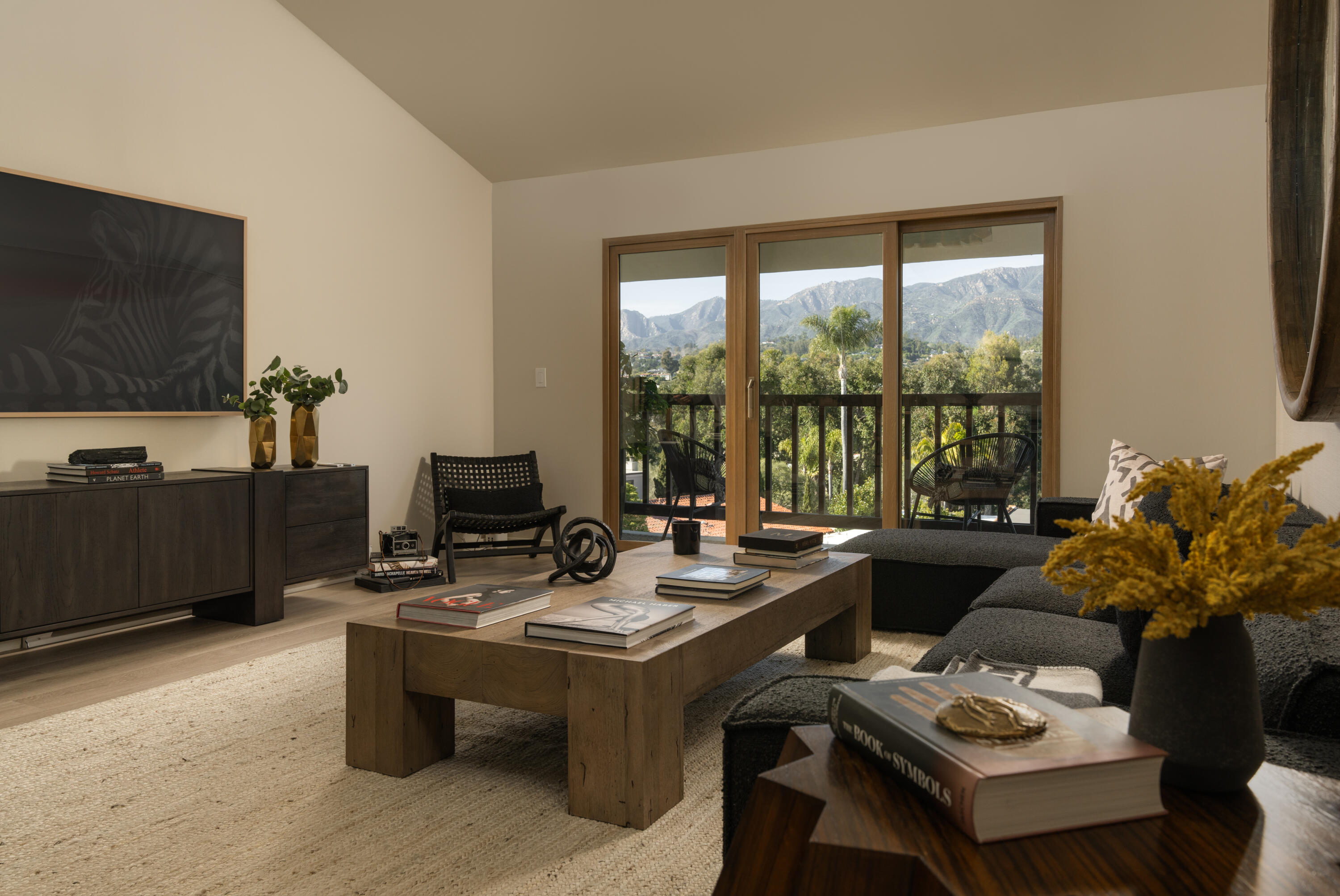 1050 Fairway Road Montecito, CA 93108 - Photo 1 of 1 a living room with furniture a flat screen tv and a large window