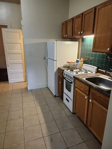 a kitchen with a stove cabinets and a refrigerator