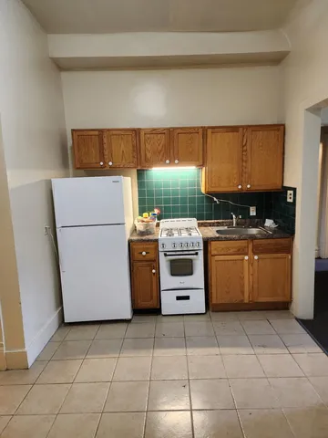 a kitchen with a cabinets and a stove top oven