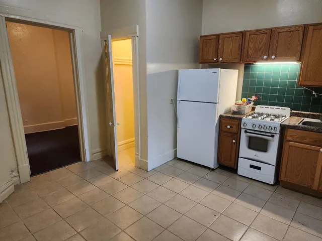 a kitchen with a refrigerator stove and sink