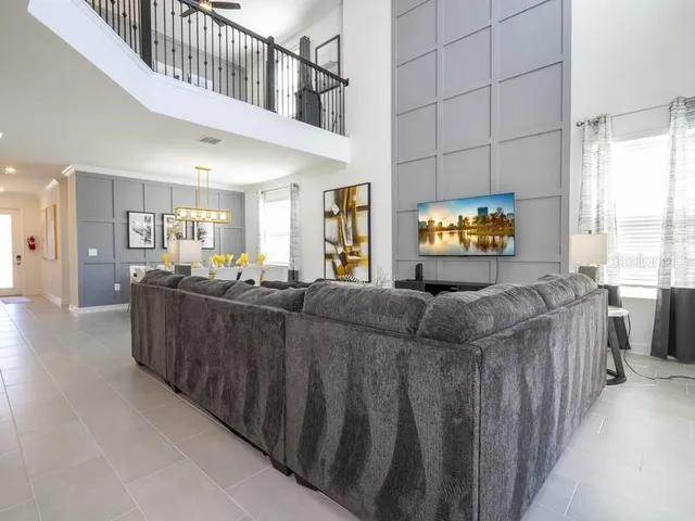 a view of a livingroom with wooden floor and a large window