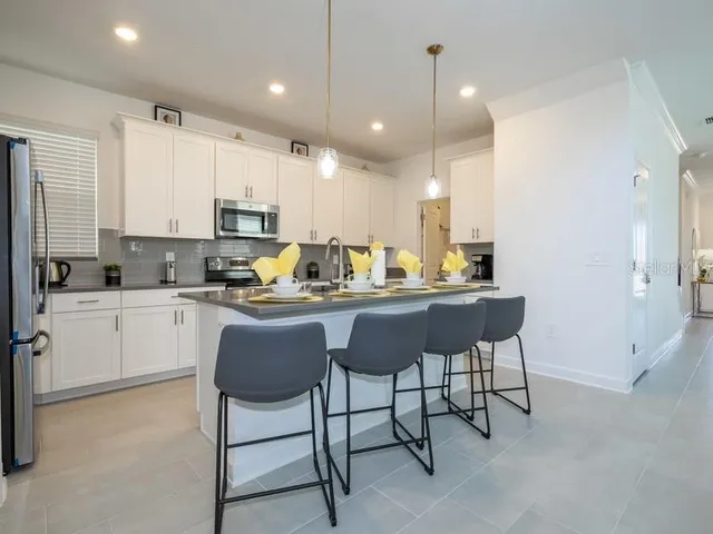 a dining room with furniture and chandelier