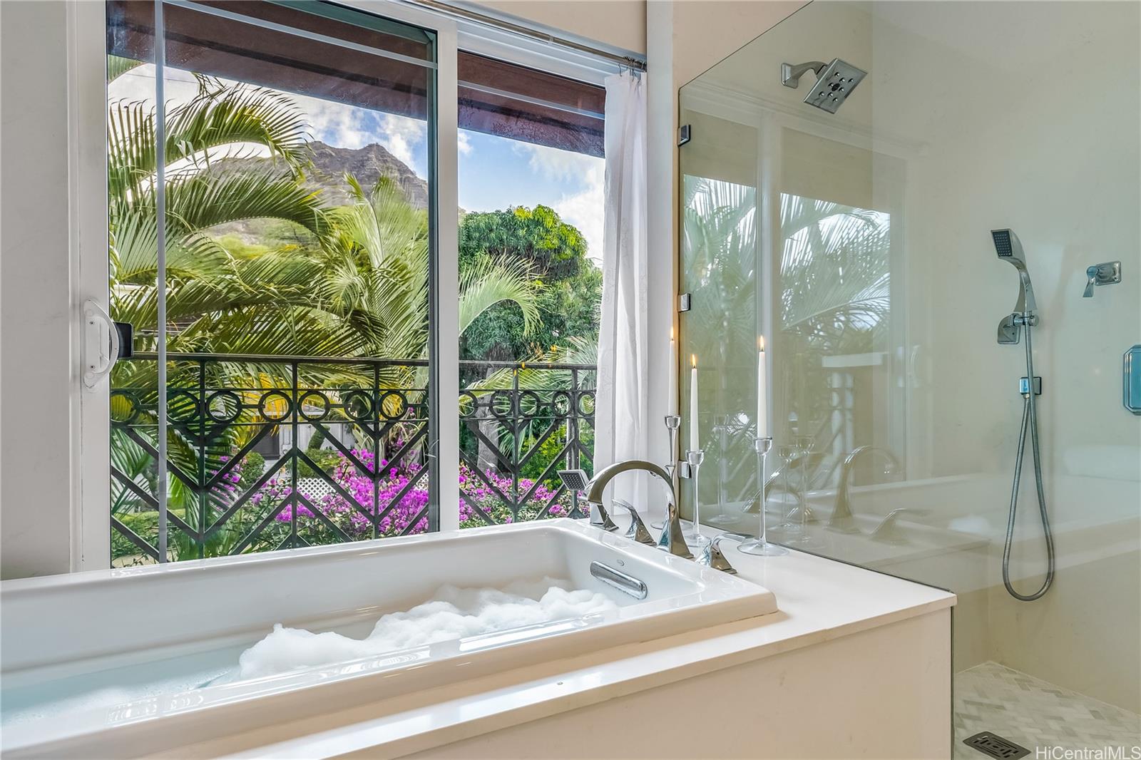 3063 Diamond Head Road Honolulu, HI 96815 - Photo 19 of 25 The Primary Suite Bathroom with tub and shower has Diamond Head views framed in by a fully landscaped yard