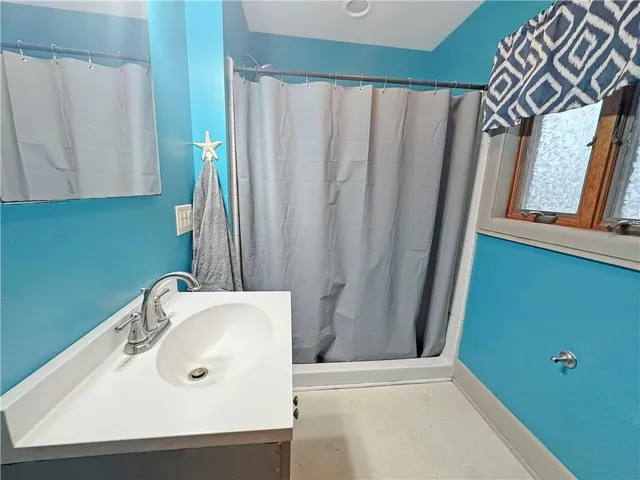 a bed room with a bed and a chandelier