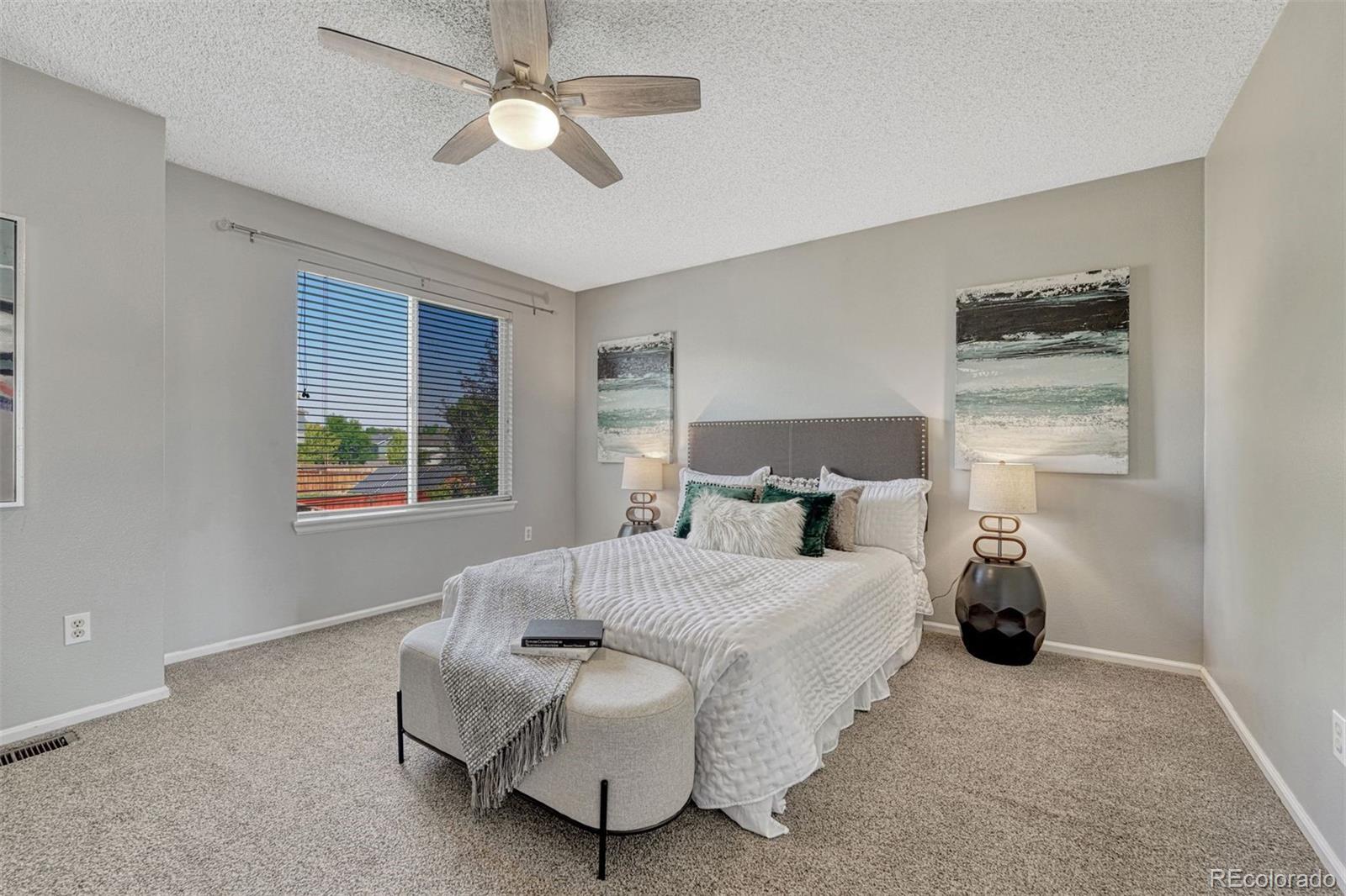 4927 Tarcoola Lane Highlands Ranch, CO 80130 - Photo 11 of 30 a bedroom with a bed and ceiling fan