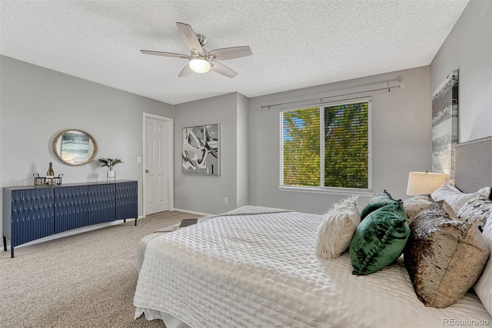 4927 Tarcoola Lane Highlands Ranch, CO 80130 - Photo 13 of 30 a bedroom with a bed dresser and a window