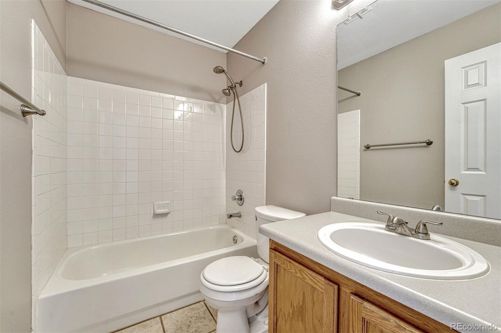 4927 Tarcoola Lane Highlands Ranch, CO 80130 - Photo 18 of 30 a bathroom with a sink a toilet and a bathtub