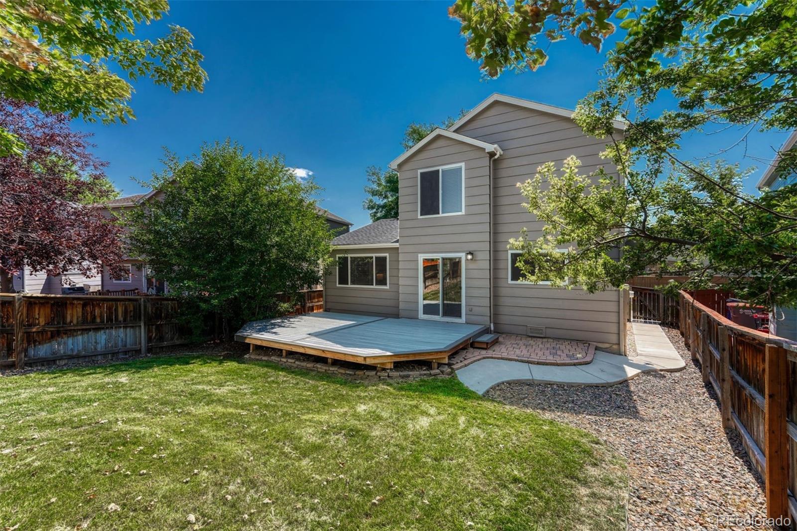 4927 Tarcoola Lane Highlands Ranch, CO 80130 - Photo 25 of 30 a front view of a house with a yard