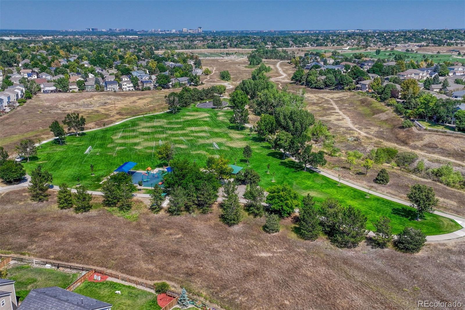 4927 Tarcoola Lane Highlands Ranch, CO 80130 - Photo 28 of 30 an aerial view of a houses with yard