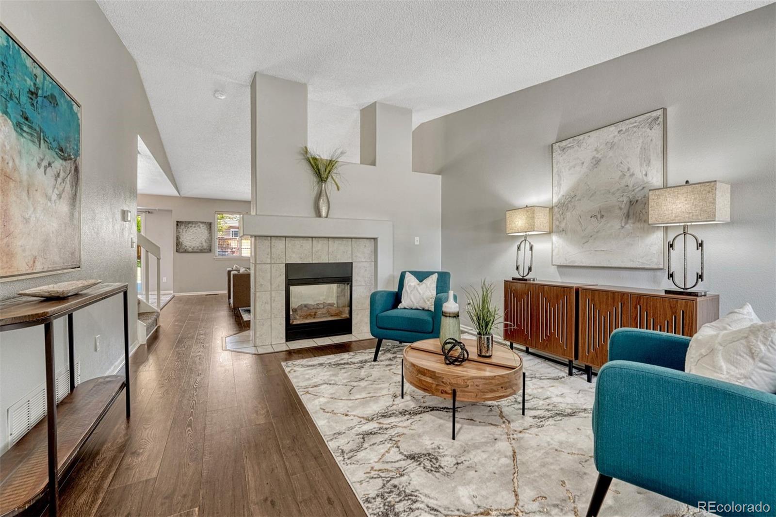 4927 Tarcoola Lane Highlands Ranch, CO 80130 - Photo 3 of 30 a living room with furniture and a fireplace