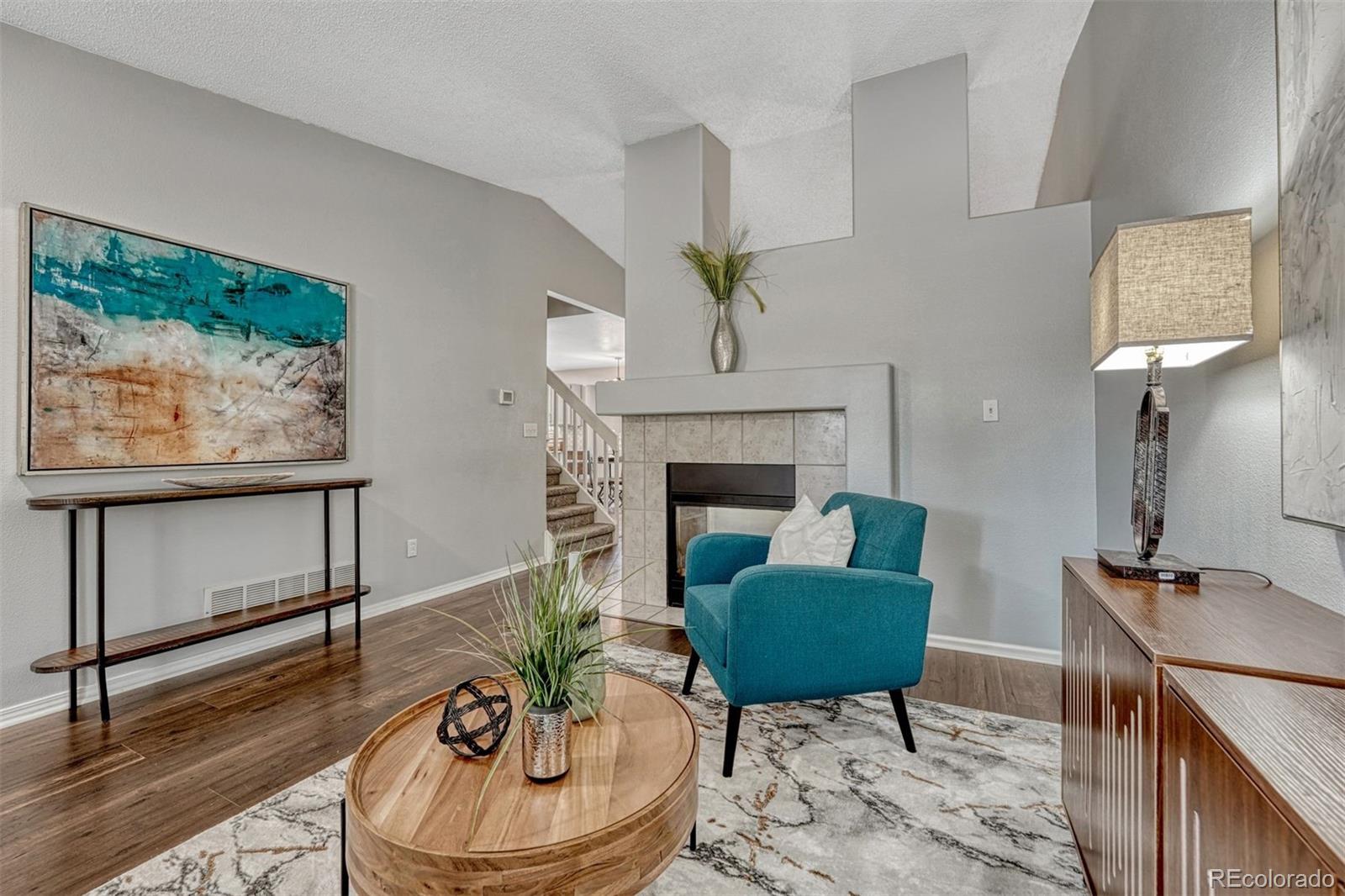 4927 Tarcoola Lane Highlands Ranch, CO 80130 - Photo 4 of 30 a living room with furniture and a fireplace