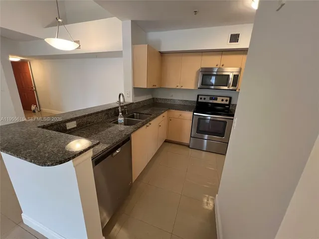 a kitchen with a sink and a refrigerator