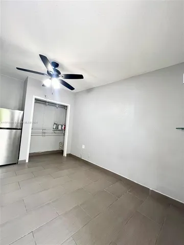 a view of an empty room and a ceiling fan