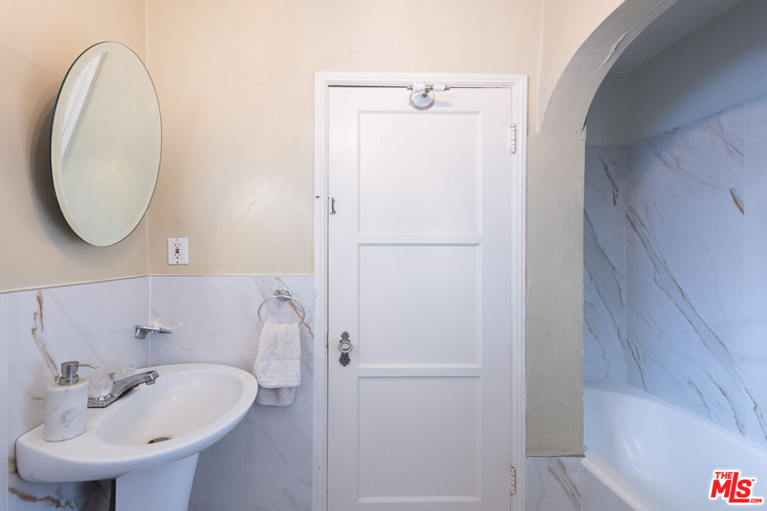 340 South Reeves Drive Beverly Hills, CA 90212 - Photo 11 of 35 a bathroom with a sink and a mirror