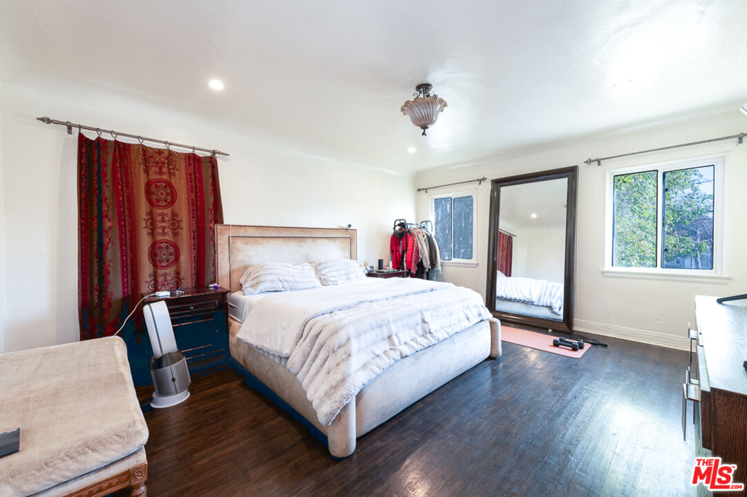 340 South Reeves Drive Beverly Hills, CA 90212 - Photo 15 of 35 a bedroom with a bed and wooden floor