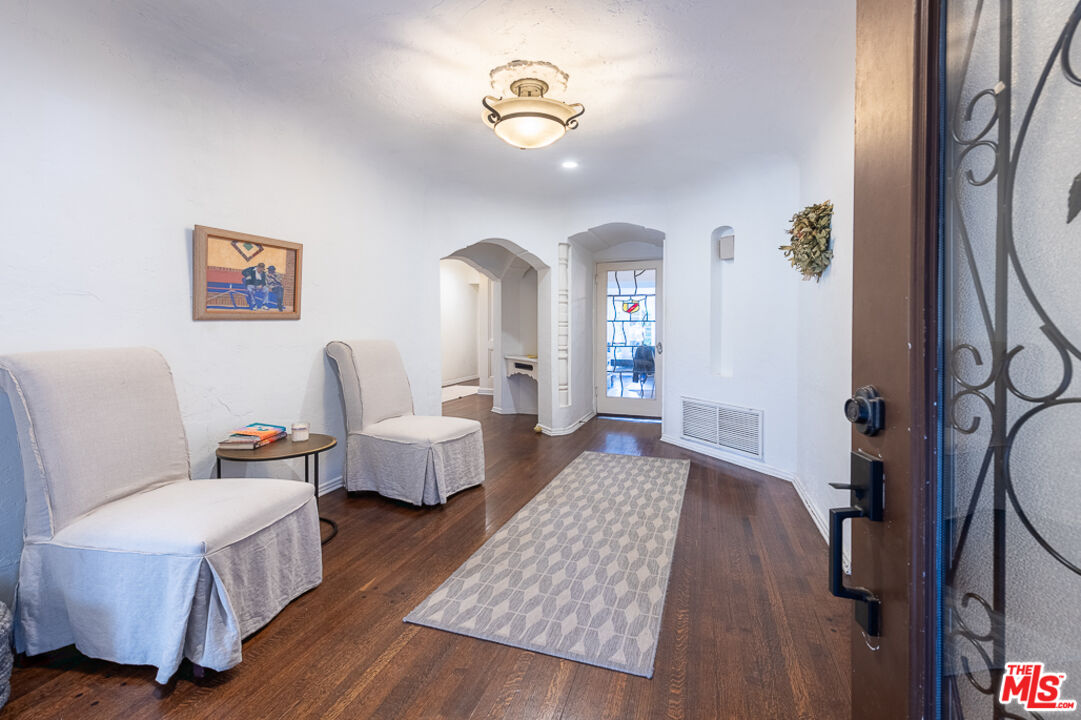 340 South Reeves Drive Beverly Hills, CA 90212 - Photo 17 of 35 a living room with furniture and a chandelier