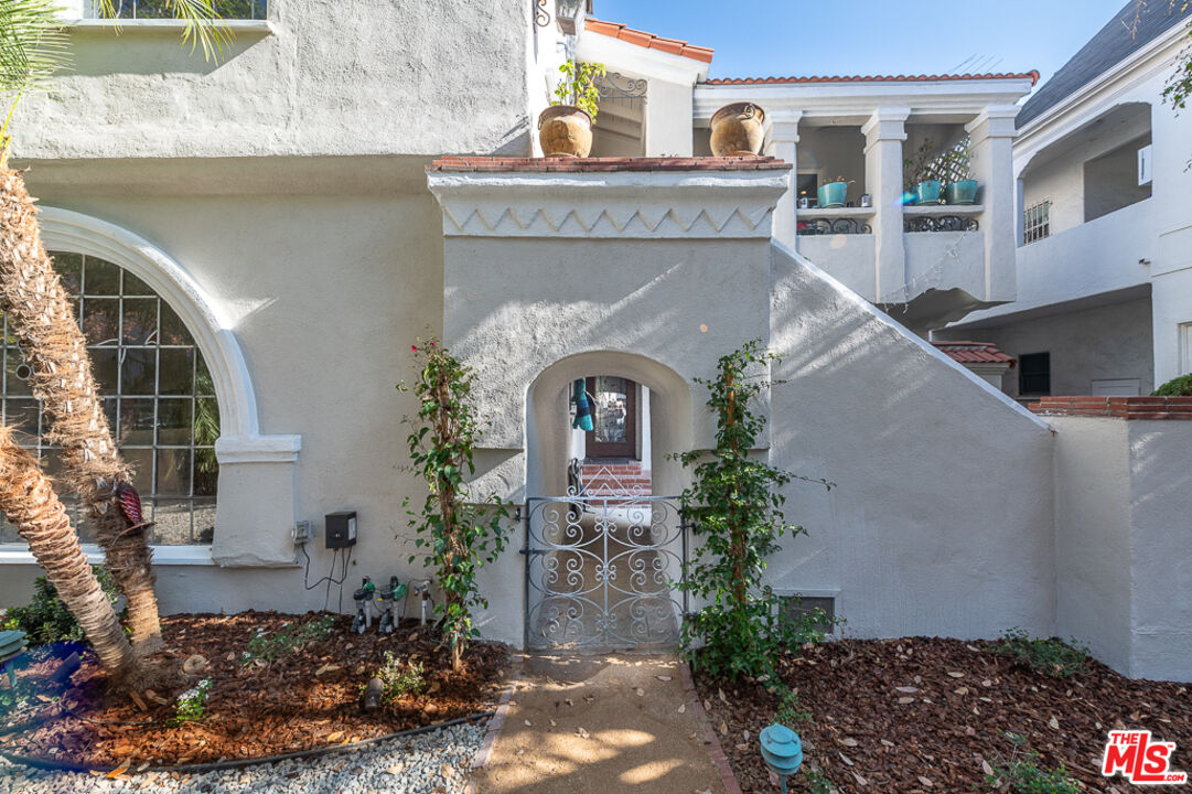 340 South Reeves Drive Beverly Hills, CA 90212 - Photo 3 of 35 a front view of a house with garden