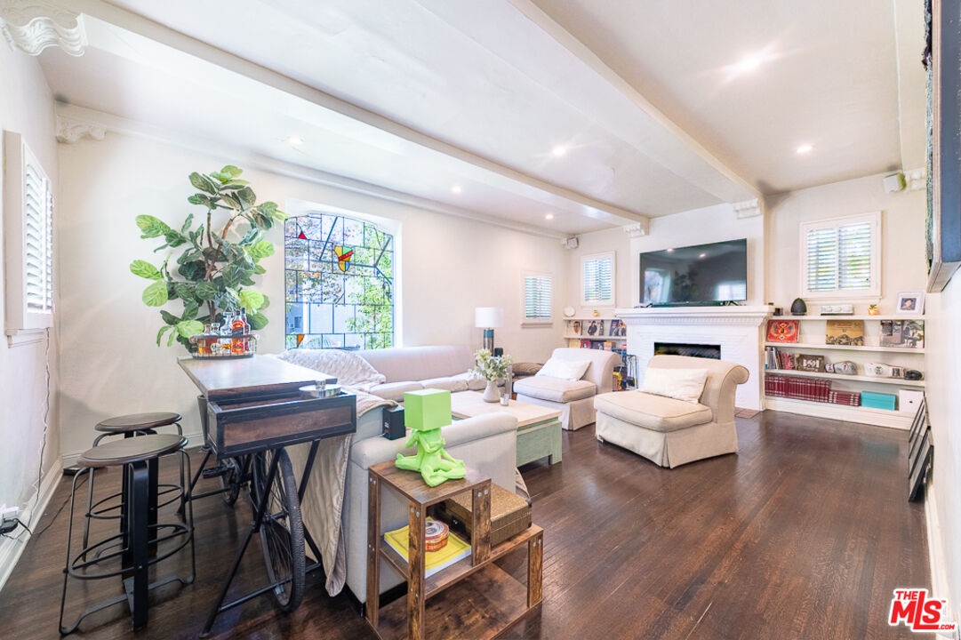 340 South Reeves Drive Beverly Hills, CA 90212 - Photo 6 of 35 a living room with fireplace furniture and a wooden floor