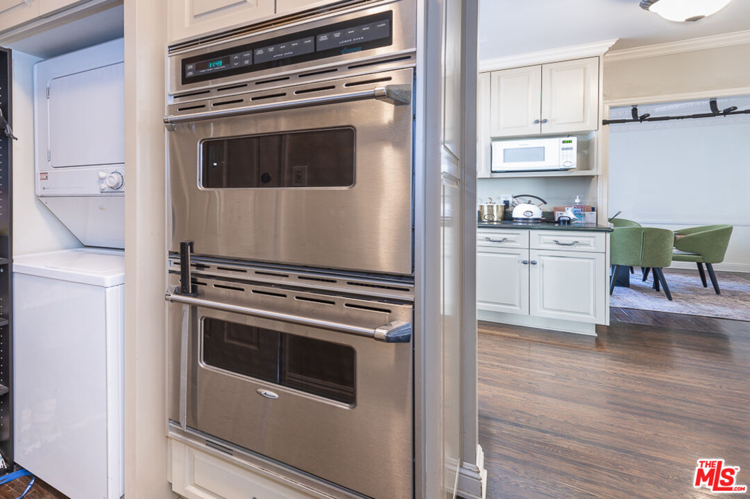 340 South Reeves Drive Beverly Hills, CA 90212 - Photo 10 of 35 a kitchen with granite countertop a stove and a microwave