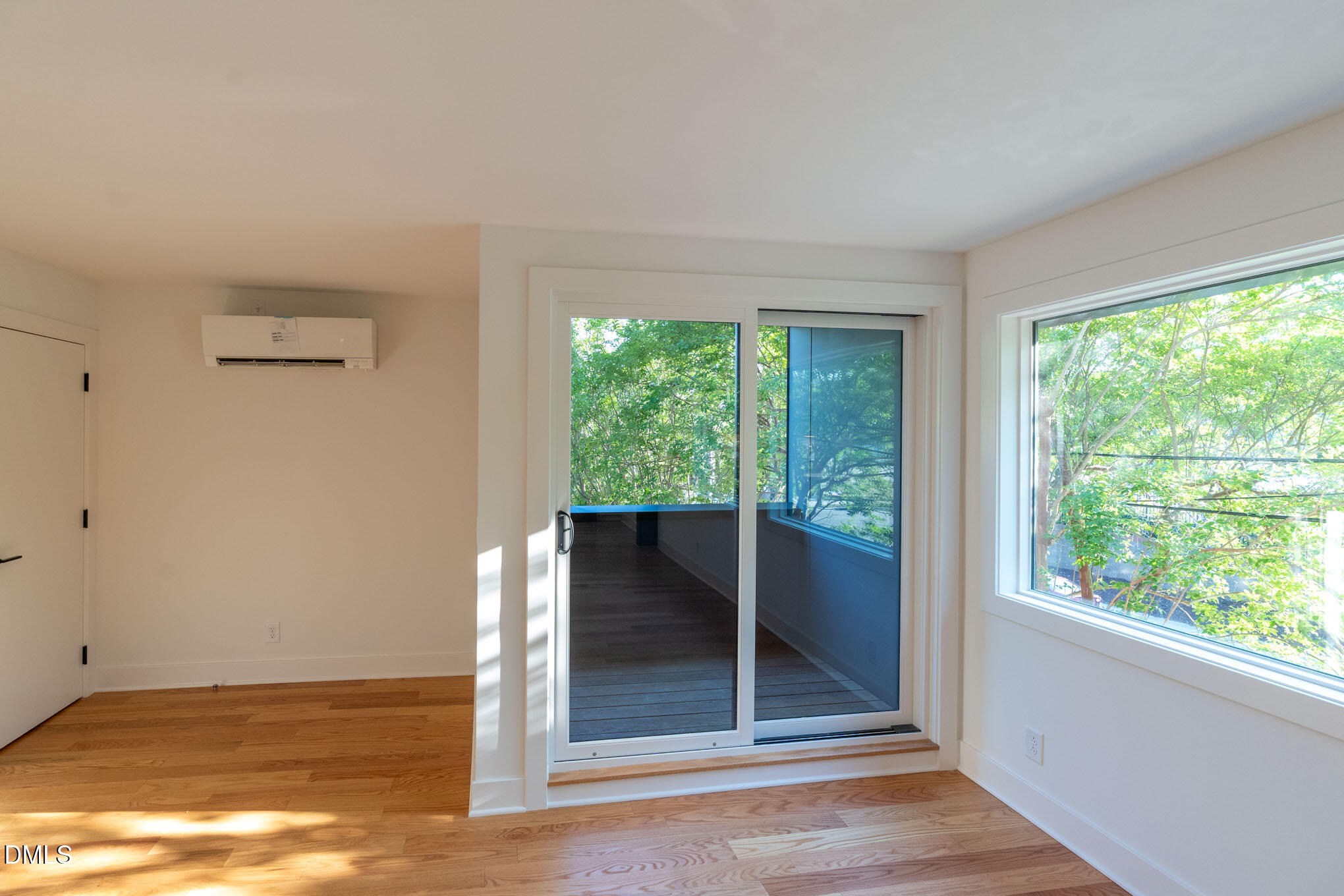 402 East Martin Street Raleigh, NC 27601 - Photo 20 of 23 a view of an empty room with wooden floor and a window