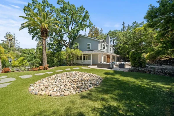 a front view of a house with garden