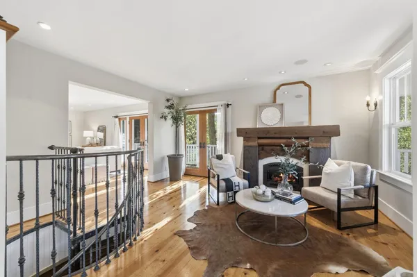 a living room with furniture window and a wooden floor