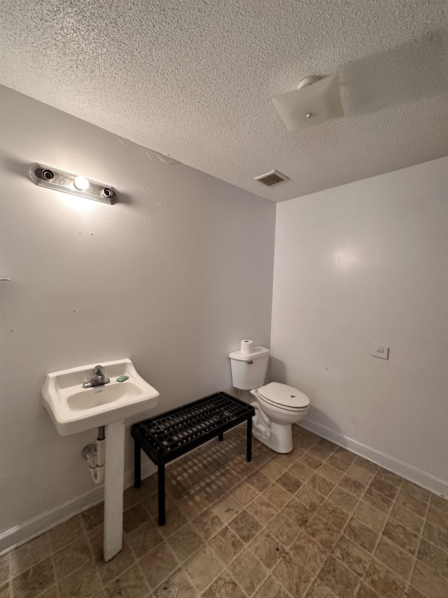 123 Lucy Avenue Memphis, TN 38106 - Photo 8 of 25 a bathroom with a toilet a sink and a mirror