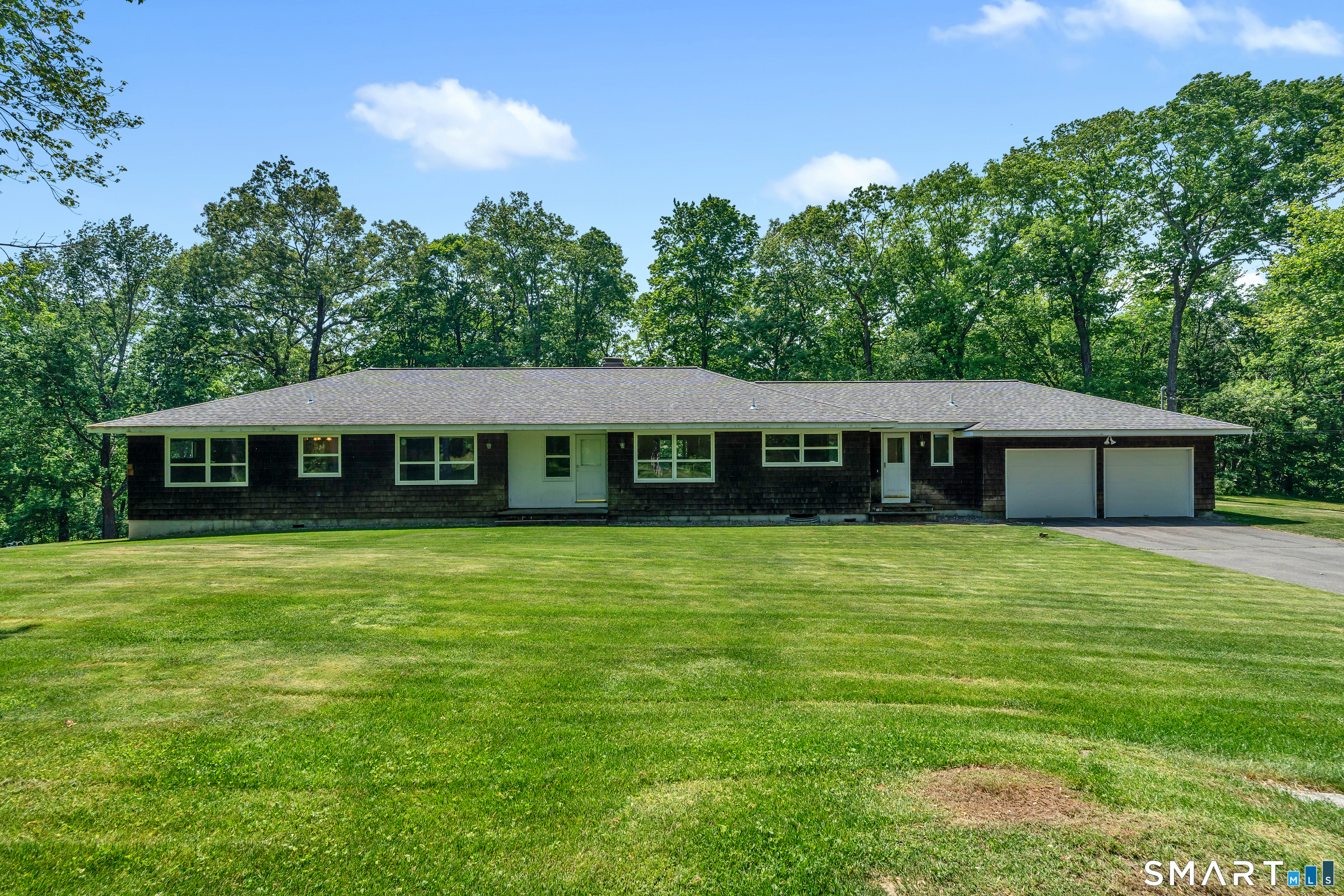 30 Maltbie Road Newtown, CT 06470 - Photo 1 of 40 a front view of a house with a garden