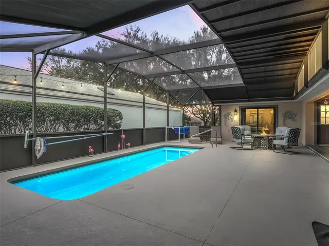 a view of a indoor swimming pool and sitting area