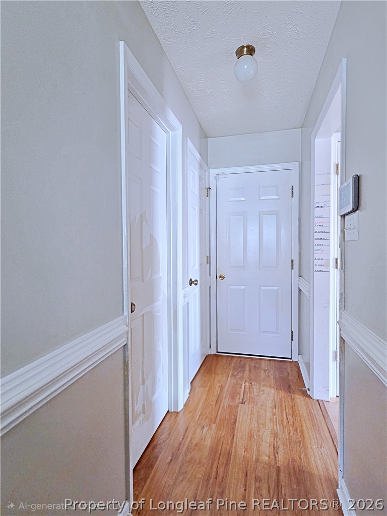5218 Pringle Way Hope Mills, NC 28348 - Photo 11 of 43 a view of a hallway with wooden floor