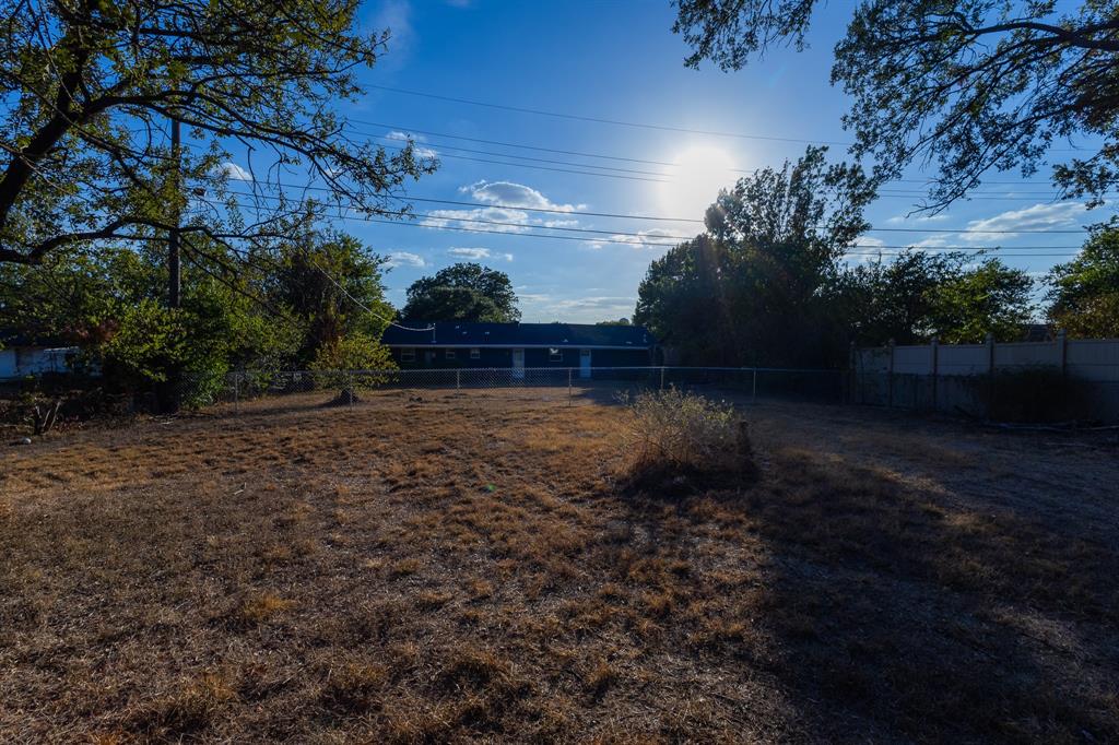 1122 Timberline Street Bellmead, TX 76705 - Photo 13 of 28 Expansive backyard with a chain-link fence and mature perimeter trees