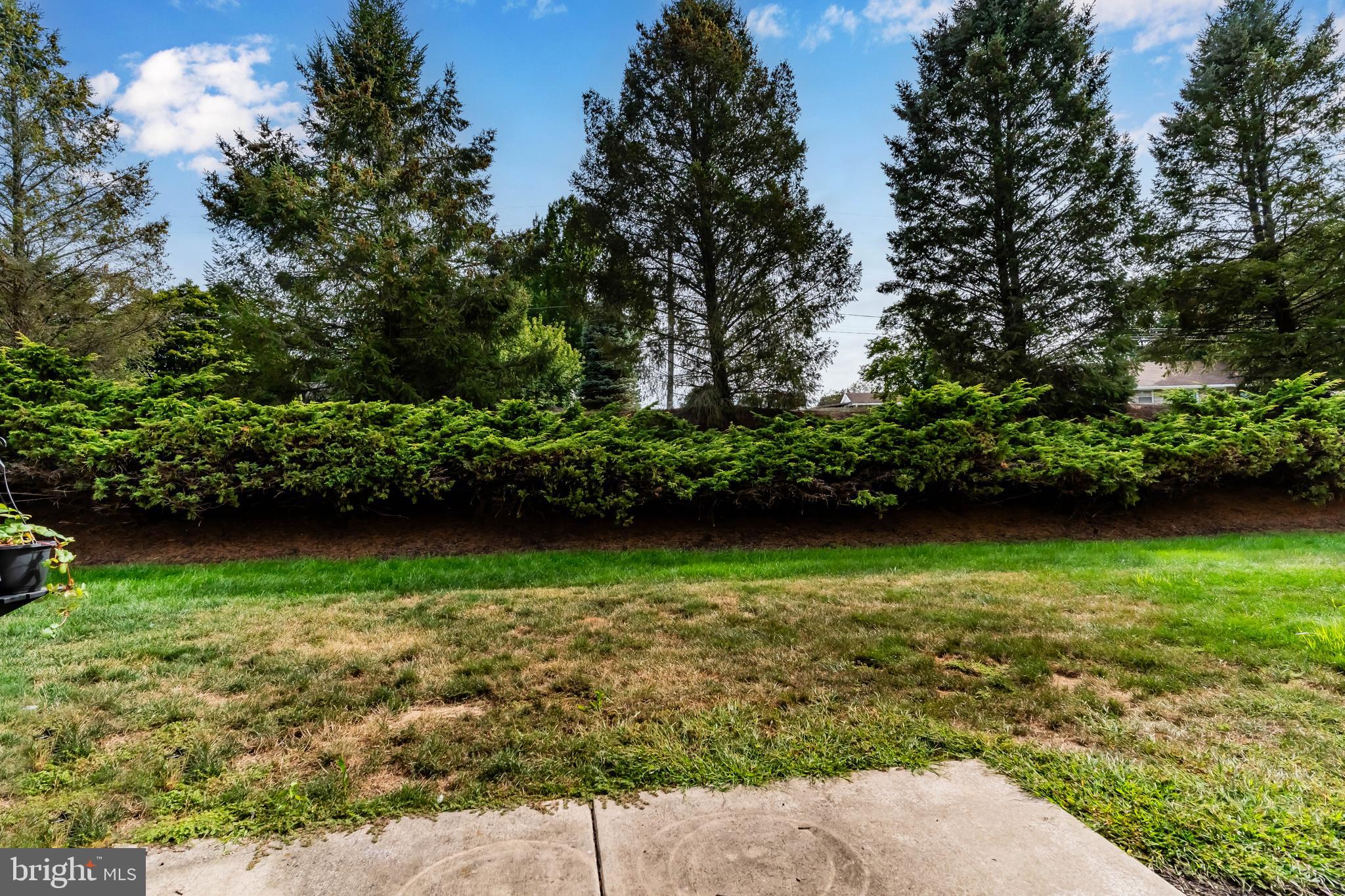 149 Cardinal Lane Hummelstown, PA 17036 - Photo 26 of 28 a view of a garden with a bench in the background