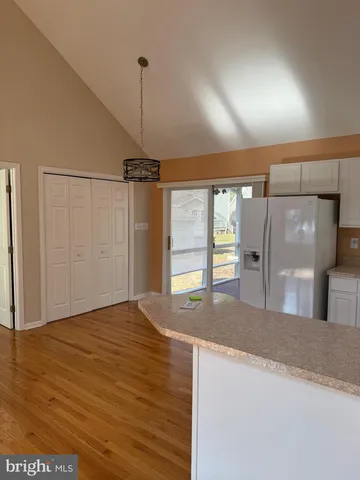 a view of a kitchen with a sink and refrigerator