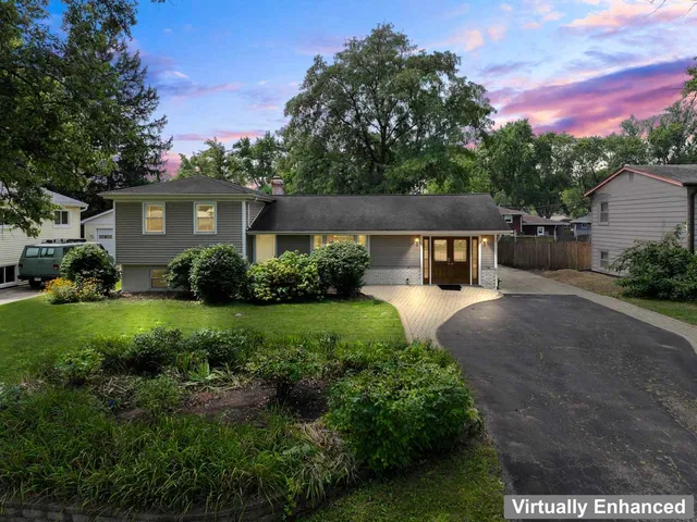 a view of a house with a yard and plants