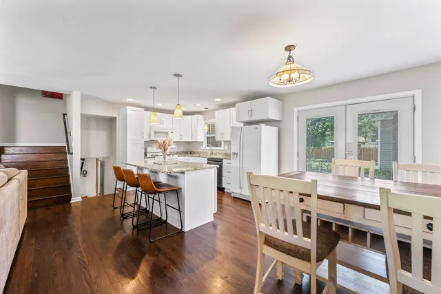 a large kitchen with a table and chairs