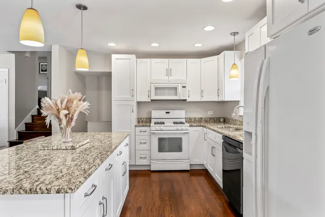 a kitchen with kitchen island granite countertop wooden cabinets and a stove