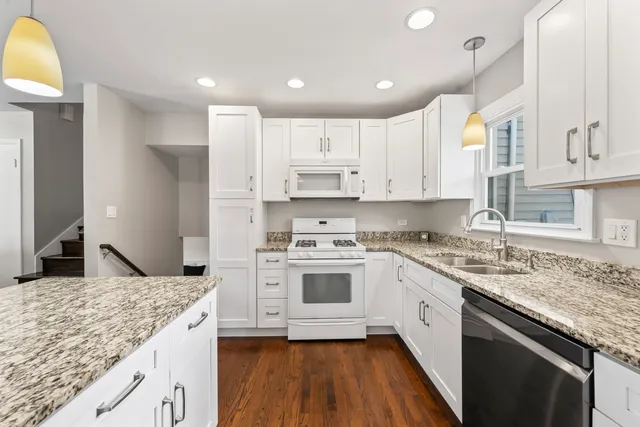 a kitchen with stainless steel appliances granite countertop a sink and cabinets