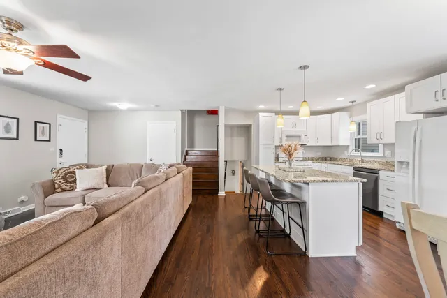 a large kitchen with a table and chairs