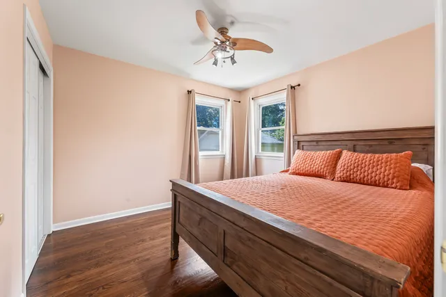 a bedroom with a bed and a large window