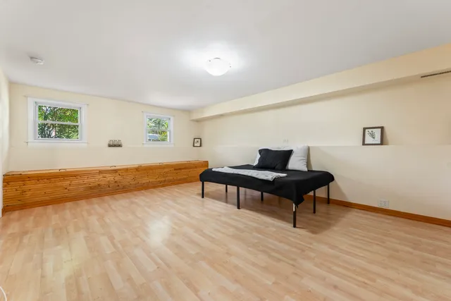 a living room with wooden floor and a table