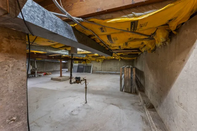 a view of empty room with wooden walls