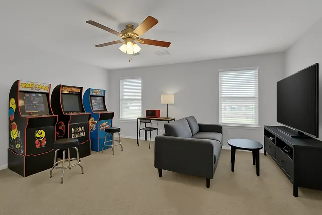 a living room with furniture and a flat screen tv with wooden floor
