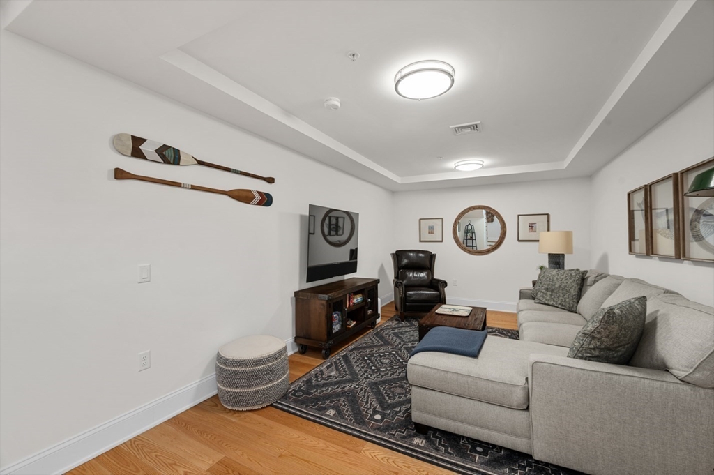 60 Merrimac Street, Unit 504 Amesbury, MA 01913 - Photo 18 of 37 a living room with furniture and a window