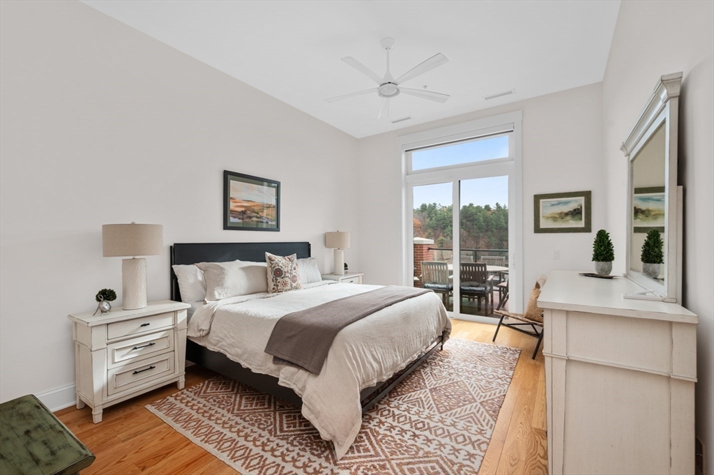 60 Merrimac Street, Unit 504 Amesbury, MA 01913 - Photo 19 of 37 a bedroom with a large bed and a large window