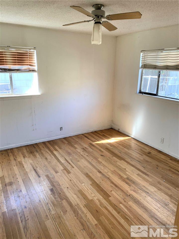 715 Reeves Avenue Reno, NV 89503 - Photo 3 of 7 an empty room with wooden floor fan and windows