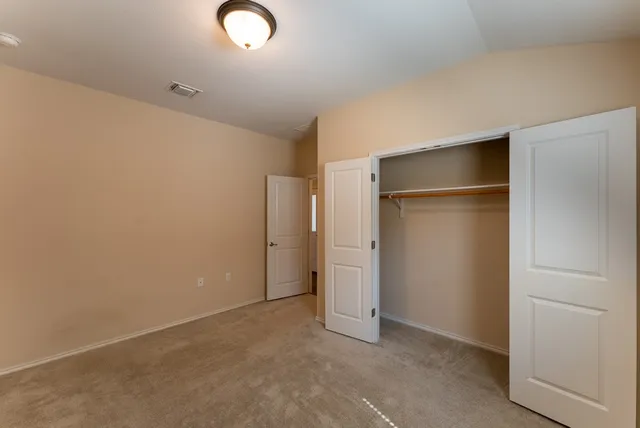 an empty room with closet area